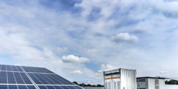 white and black solar panels under white clouds and blue sky during daytime