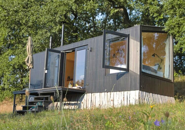 a small house sitting on top of a lush green field