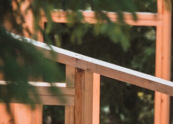 A man riding a skateboard on top of a wooden rail