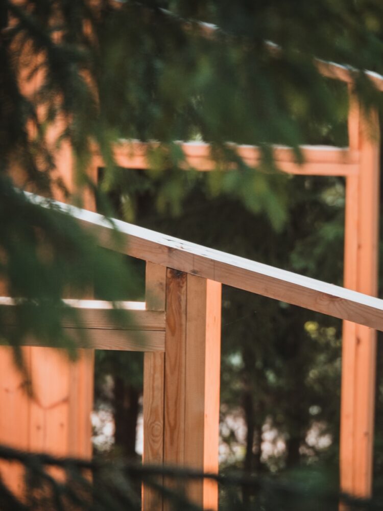 A man riding a skateboard on top of a wooden rail