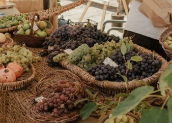 a table topped with baskets filled with lots of fruit