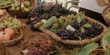 a table topped with baskets filled with lots of fruit