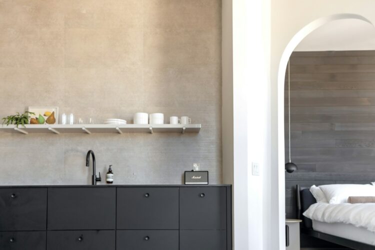 A modern kitchen opens to a bedroom.