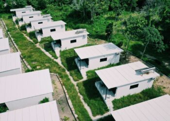 white concrete building near green trees during daytime