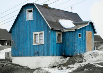blue and white wooden house on white snow covered ground during daytime