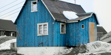blue and white wooden house on white snow covered ground during daytime