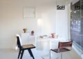 A white room with a table and chairs