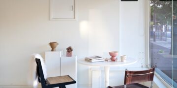 A white room with a table and chairs