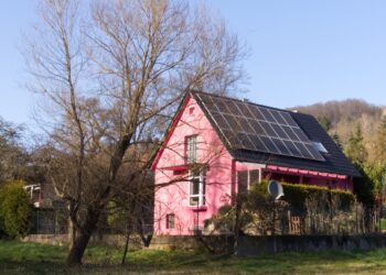 a red barn with a black roof