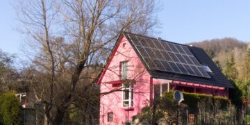 a red barn with a black roof