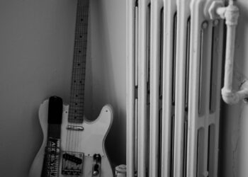 a guitar and a radiator in a room