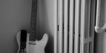 a guitar and a radiator in a room