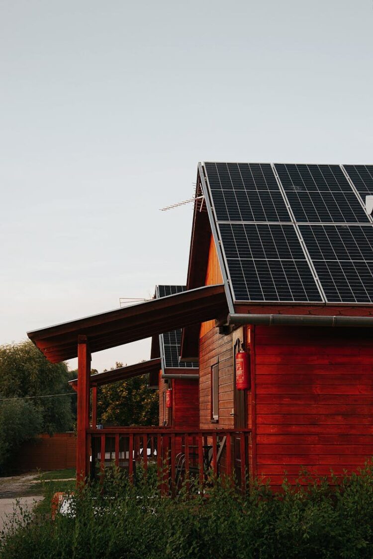 Wooden house featuring solar panels, captured at sunset, highlighting eco-friendly architecture.