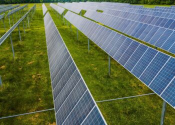 Aerial view of solar panels in a green field, Rossville, GA.