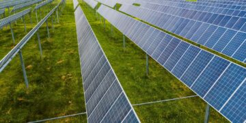Aerial view of solar panels in a green field, Rossville, GA.