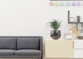 Bright and stylish minimalist living space with modern kitchen decor and cozy sofa.