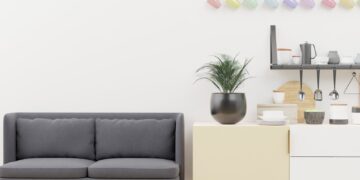 Bright and stylish minimalist living space with modern kitchen decor and cozy sofa.