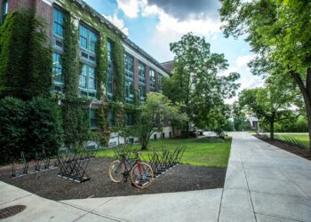 black bicycle parked in front of building