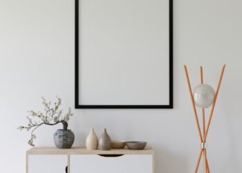 Elegant minimalist interior with empty frame, credenza, and modern decor.