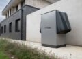 Innovative heat pump system by alpha innotec installed outside a contemporary building.