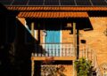 A picturesque Brazilian house featuring solar panels, captured during sunset for a warm, inviting ambiance.