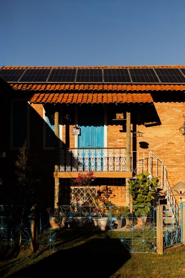 A picturesque Brazilian house featuring solar panels, captured during sunset for a warm, inviting ambiance.