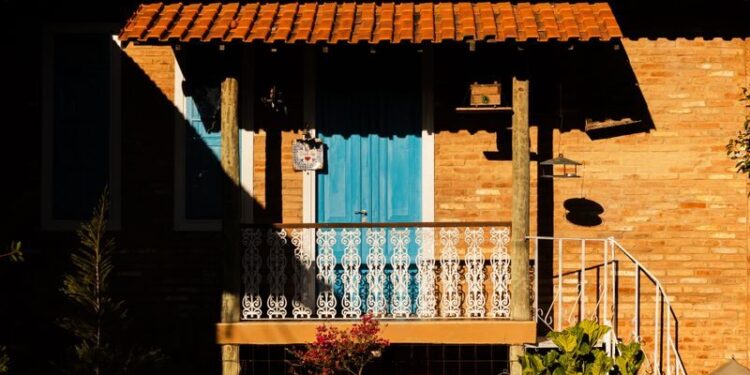 A picturesque Brazilian house featuring solar panels, captured during sunset for a warm, inviting ambiance.