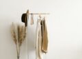 A chic minimalist clothing rack with neutral garments in a bright, modern setting.